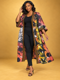 Model wearing the Sunset Batik Long Kimono in orange, black and white African batik print by ILÉ AYỌ̀KÁ.