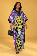 Model wearing a purple, yellow, black and white batik maxi bubu dress by ILÉ AYỌ̀KÁ.