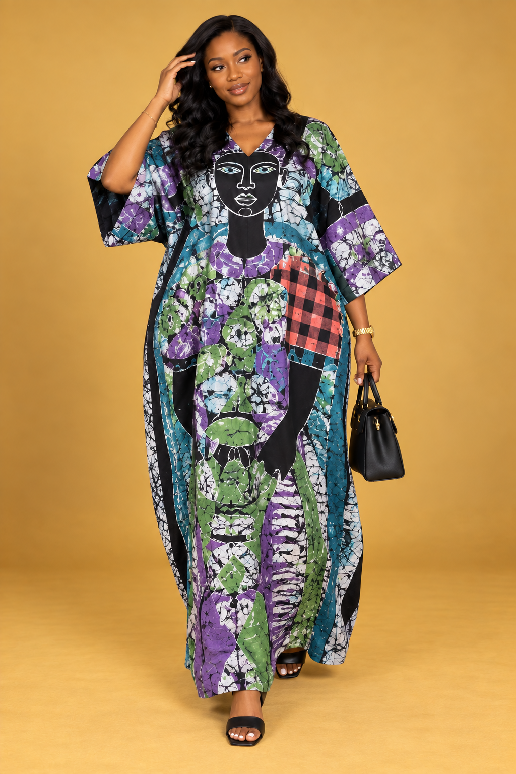 Front view of a black maxi bubu with purple, yellow and white batik print by ILÉ AYỌ̀KÁ.