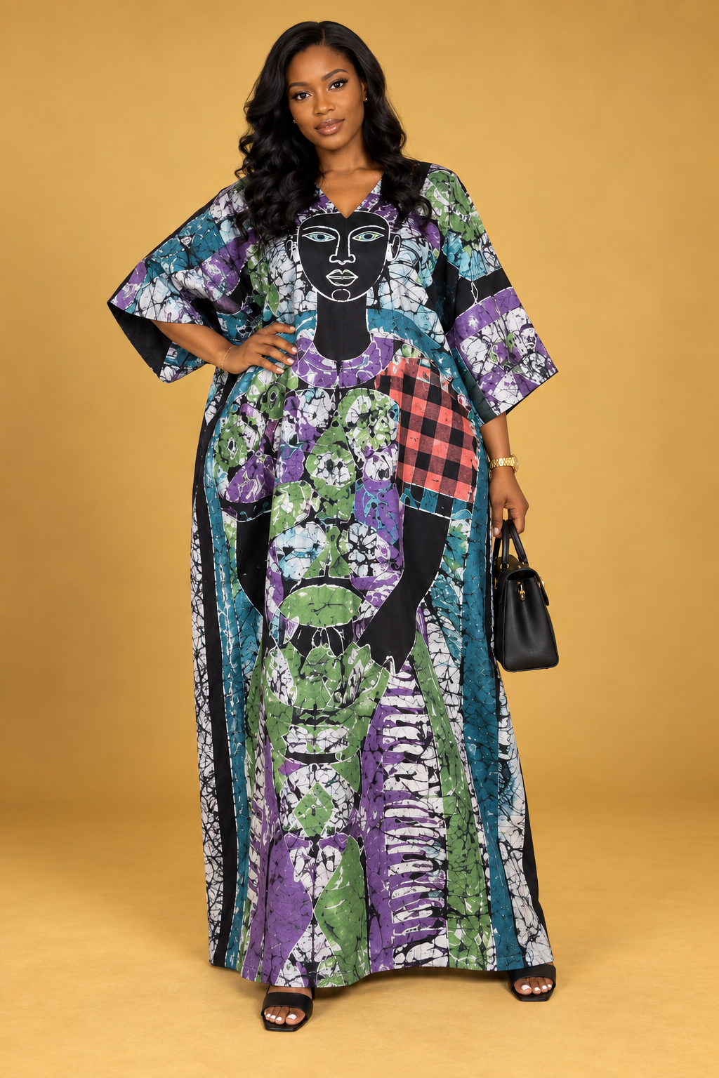 Front view of a black maxi bubu with purple, yellow and white batik print by ILÉ AYỌ̀KÁ.